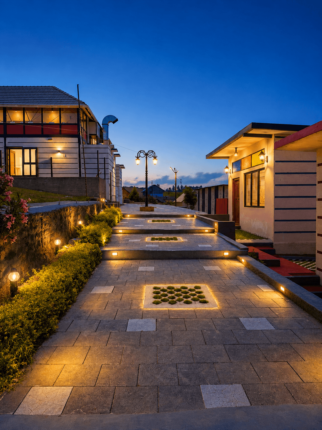 Illuminated courtyard and hillside resort buildings at dusk